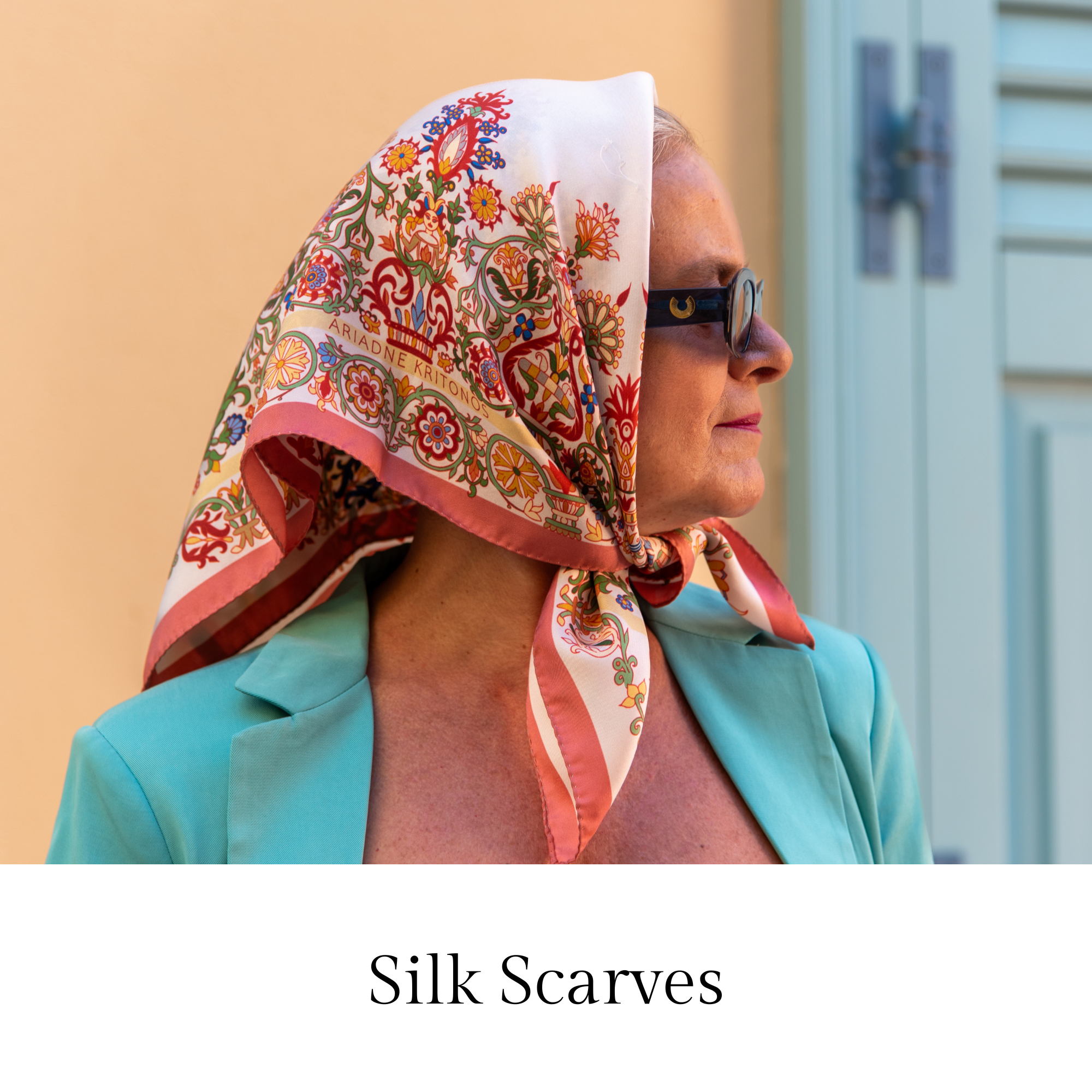Image of two women wearing silk scarves designed by Ariadne Kritonos. The scarves have rich and complex designs and they are available in vibrant colors.