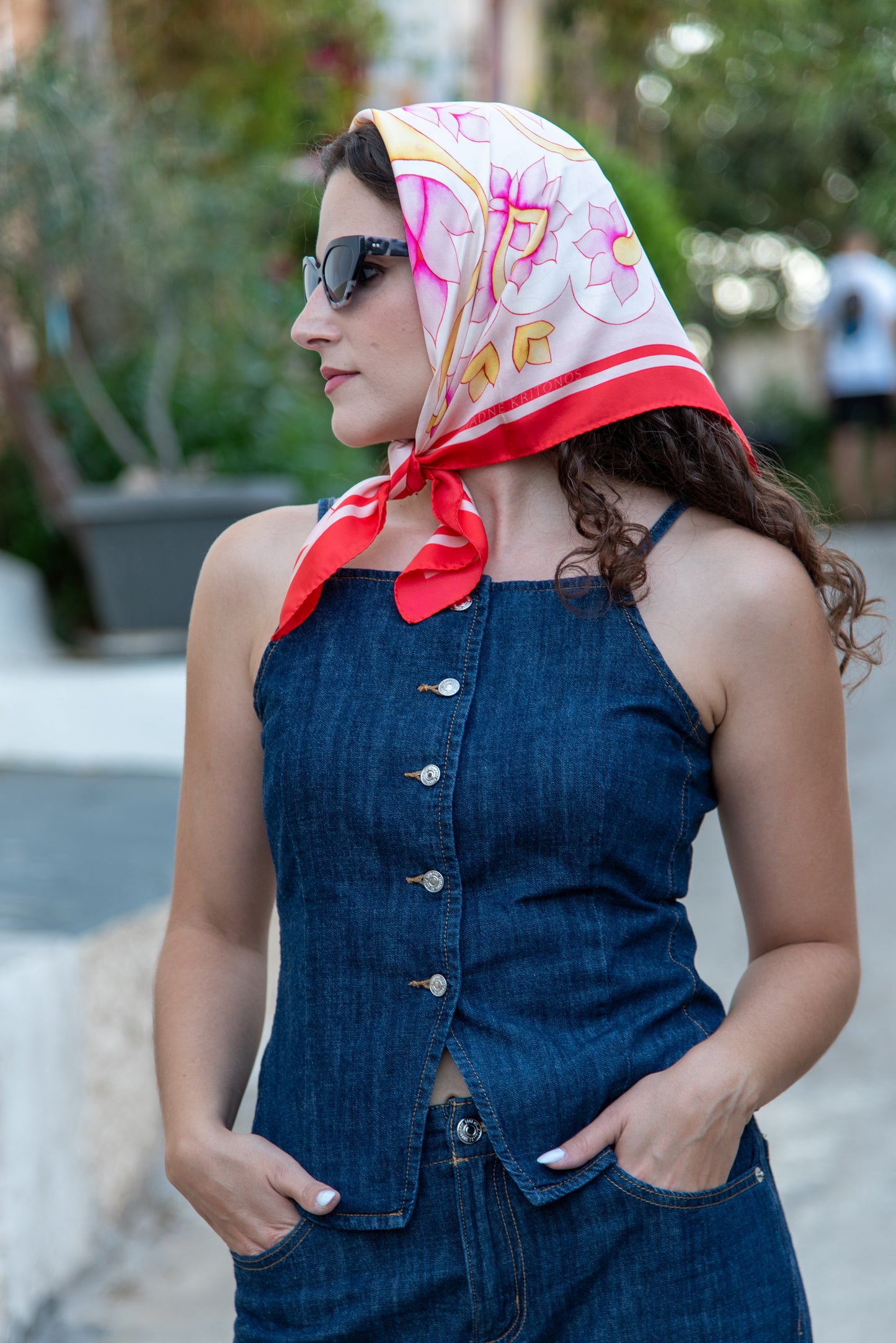 model wearing pink Attica Garden silk scarf tied as headscarf, Greek folk art design by Ariadne Kritonos