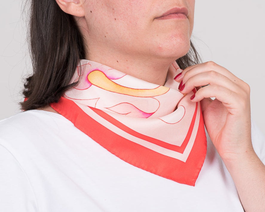 Pink Attica Garden silk scarf tied simply on neck over white t-shirt