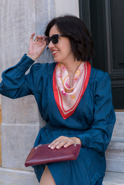 Attica Garden hand-drawn pink and red silk scarf tied loosely on neck
