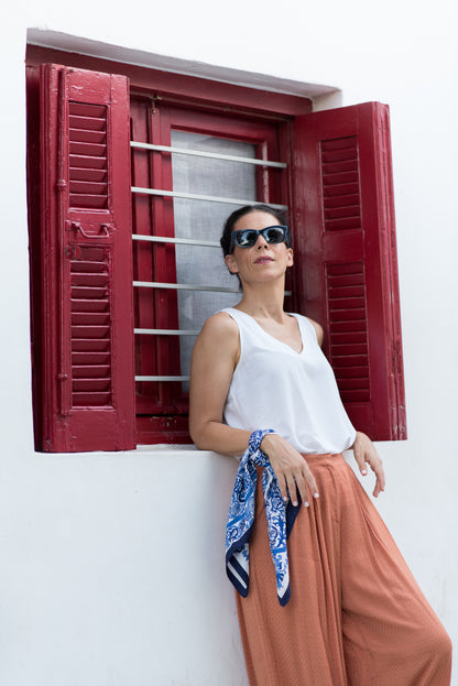 Luxury mulberry silk scarf in blue worn elegantly on wrist
