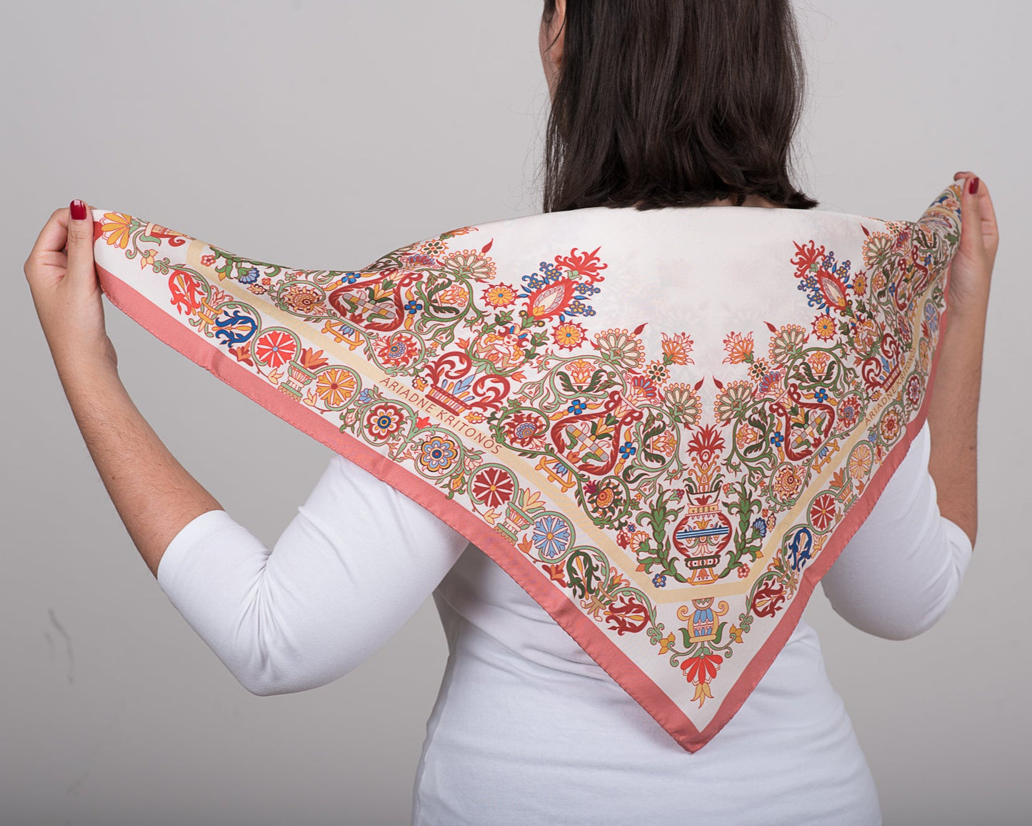 Colorful Cretan inspired mermaid scarf held over the models back to show the design