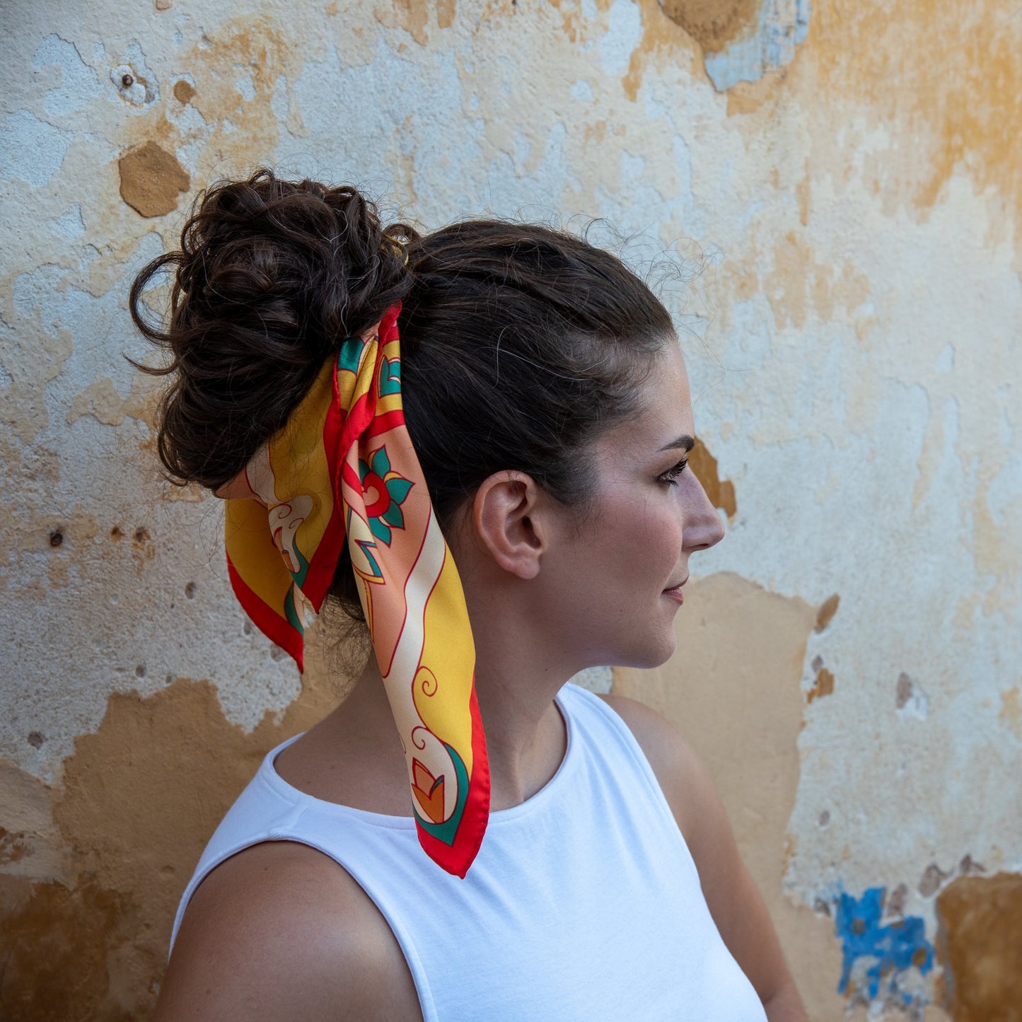 Model wearing Yellow, Pink and Red Mesogeia Blooms silk scarf in her stunning an updo